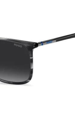 Graue Sonnenbrille aus gemustertem Acetat mit röhrenförmigen Metallbügeln