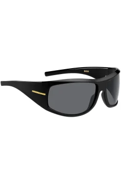 Schwarze Sonnenbrille im Masken-Stil mit goldfarbenen Metalldetails