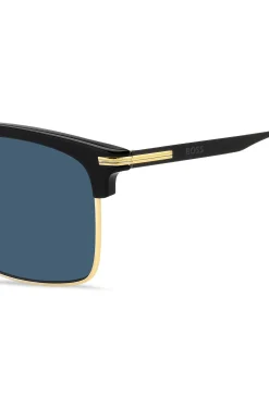 Sonnenbrille mit blauen Gläsern und schwarz-goldfarbener Fassung