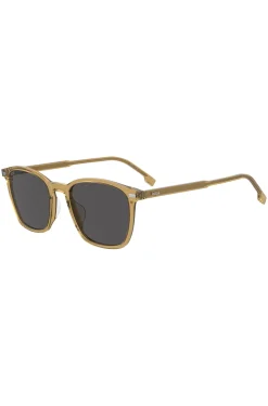 Transparente, beigefarbene Sonnenbrille mit grauen Gläsern